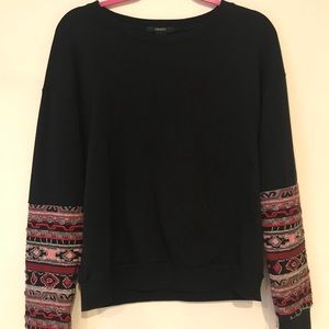 Oversized black sweater with embellished sleeves